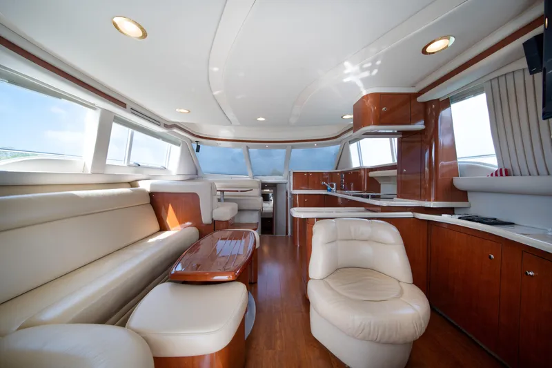 Slide: The Image of Luxurious interior of 2003 Sea Ray 480 Sedan Bridge yacht with leather seating and wood finishes. - 23