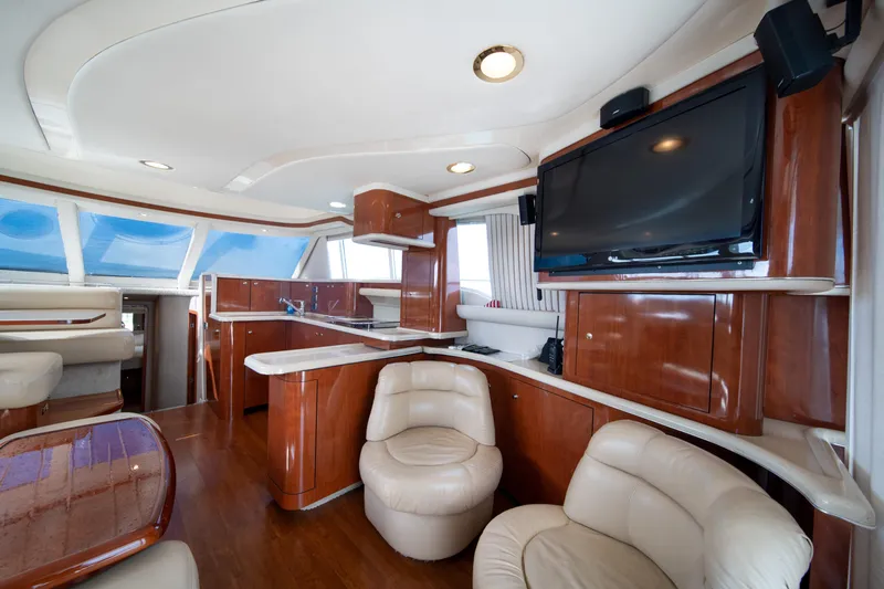 Slide: The Image of Luxurious interior of 2003 Sea Ray 480 Sedan Bridge yacht with leather seating and wood finishes. - 24