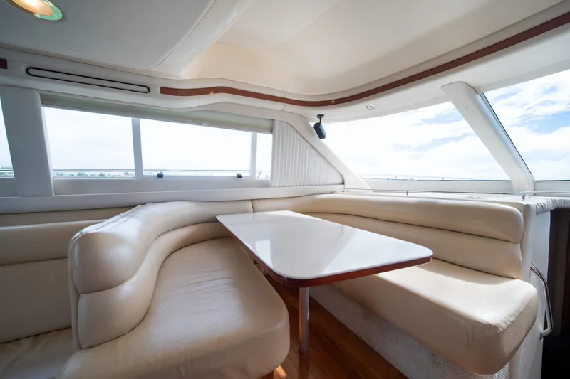 Slide: The Image of Luxurious interior of 2003 Sea Ray 480 Sedan Bridge yacht with plush seating and table. - 27
