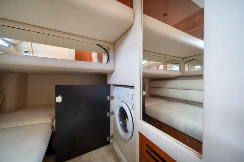 Slide: The Image of Interior of 2003 Sea Ray 480 Sedan Bridge with washer and cozy sleeping area. - 28