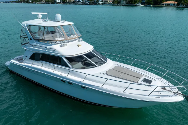 Slide: The Image of 2003 Sea Ray 480 Sedan Bridge yacht cruising on clear blue water. - 4