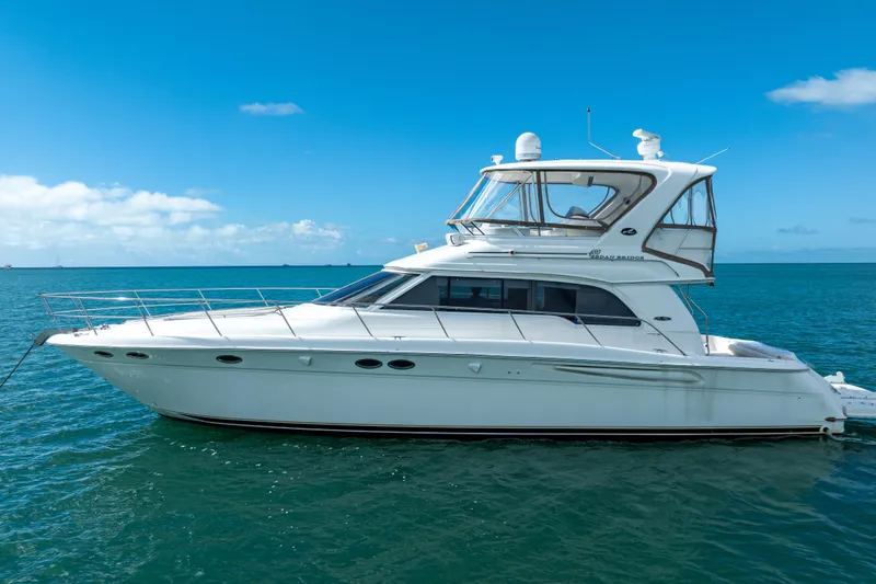 Slide: The Image of 2003 Sea Ray 480 Sedan Bridge yacht on calm blue ocean. - 6