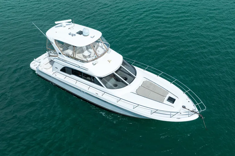 Slide: The Image of 2003 Sea Ray 480 Sedan Bridge yacht on clear blue water. - 8