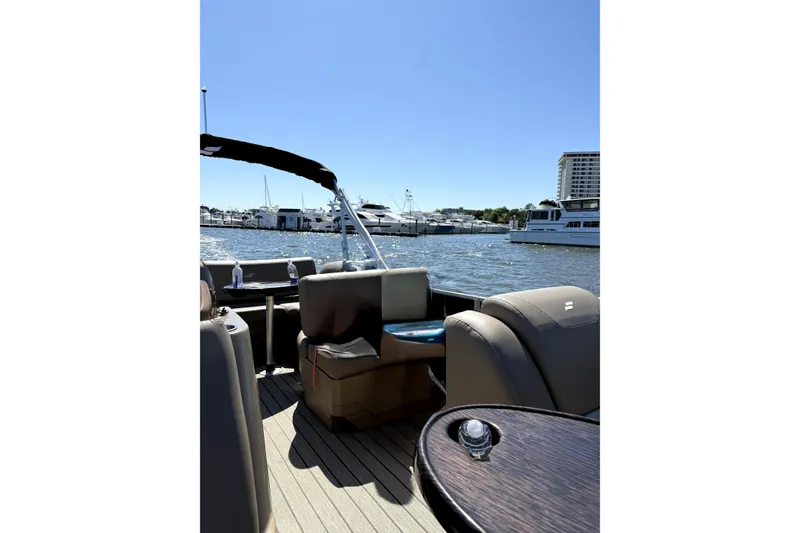 Slide: The Image of 2022 Starcraft CX 23 Q pontoon boat interior with marina view. - 12