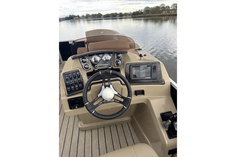 Slide: The Image of Steering console of 2022 Starcraft CX 23 Q boat with navigation system. - 16