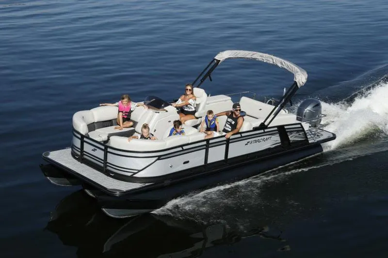 Slide: The Image of Manufacturer Provided Image: 2022 Starcraft CX 23 Q pontoon boat cruising with passengers on a lake. - 2