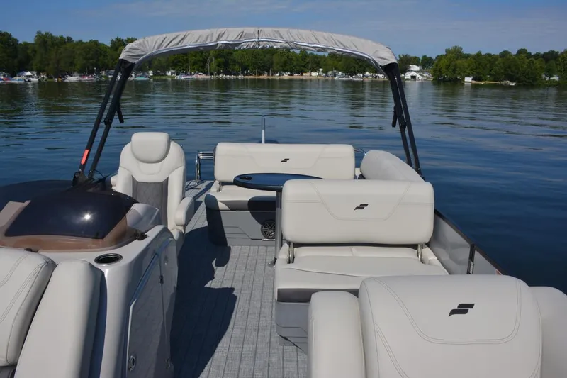 Slide: The Image of Manufacturer Provided Image: 2022 Starcraft CX 23 Q pontoon boat interior on a calm lake. - 5