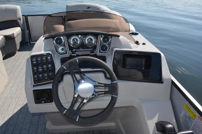 Slide: The Image of Manufacturer Provided Image: 2022 Starcraft CX 23 Q boat dashboard with steering wheel and control panel. - 7