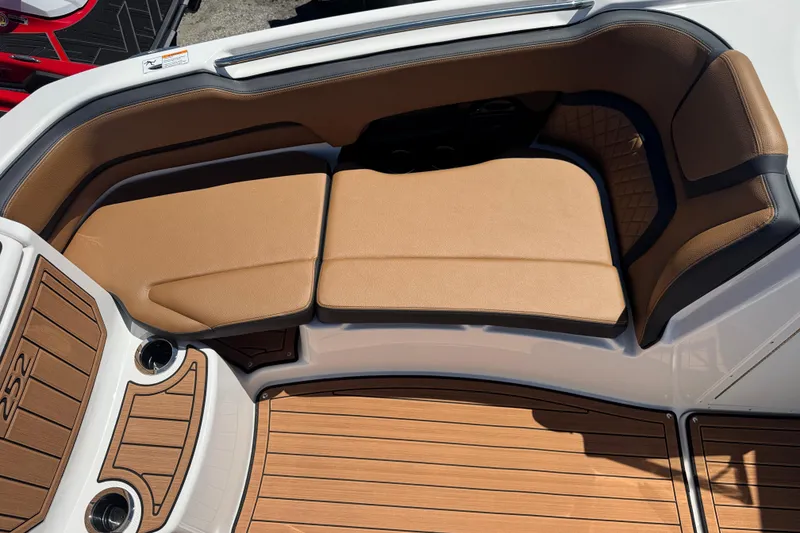 Slide: The Image of 2026 Yamaha Boats 252SD interior with tan seating and wood-style flooring. - 13
