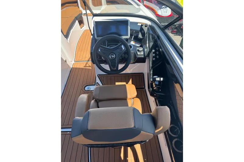 Slide: The Image of 2026 Yamaha Boats 252SD cockpit with modern steering and controls, featuring sleek design and wood accents. - 23