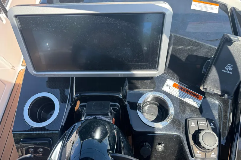 Slide: The Image of 2026 Yamaha Boats 252SD dashboard with touchscreen, controls, and cup holders. - 26