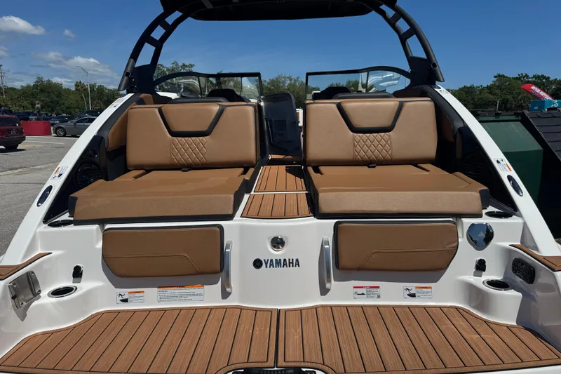 Slide: The Image of 2026 Yamaha Boats 252SD with tan seating and teak flooring, rear view. - 3