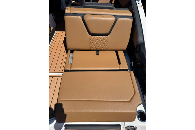 Slide: The Image of 2026 Yamaha Boats 252SD, tan leather seating with diamond stitching, on teak-style flooring. - 5
