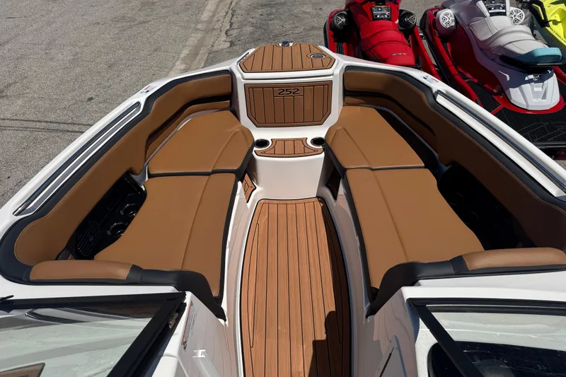 Slide: The Image of 2026 Yamaha Boats 252SD interior with tan seating and wood-style flooring. - 9