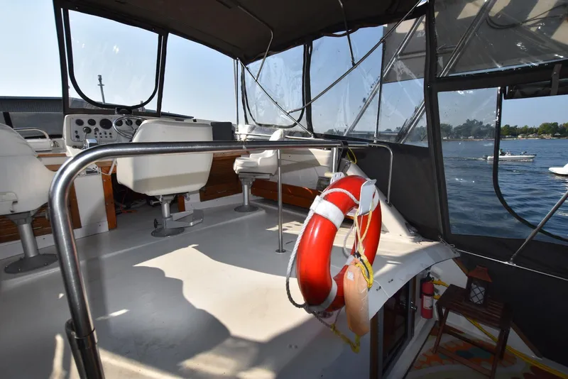 Slide: The Image of 1985 Silverton 40 Aft Cabin boat interior with steering wheel and life preserver. - 11