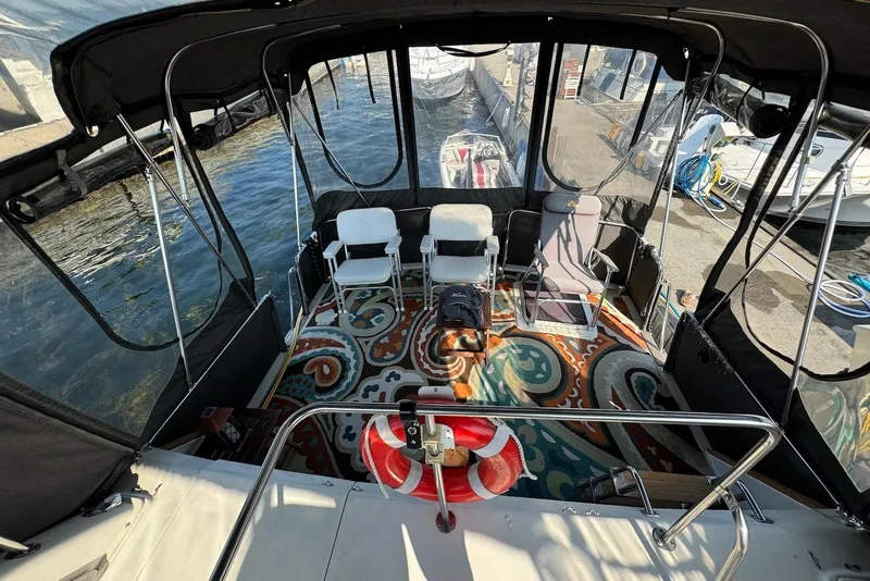 Slide: The Image of 1985 Silverton 40 Aft Cabin boat interior with chairs and colorful rug. - 12
