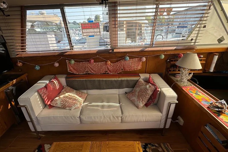 Slide: The Image of Interior of 1985 Silverton 40 Aft Cabin with cozy sofa and decorative pillows. - 14