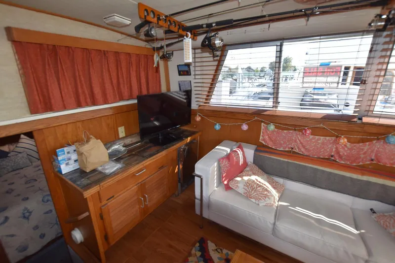 Slide: The Image of Interior of 1985 Silverton 40 Aft Cabin with cozy seating and decorative accents. - 15