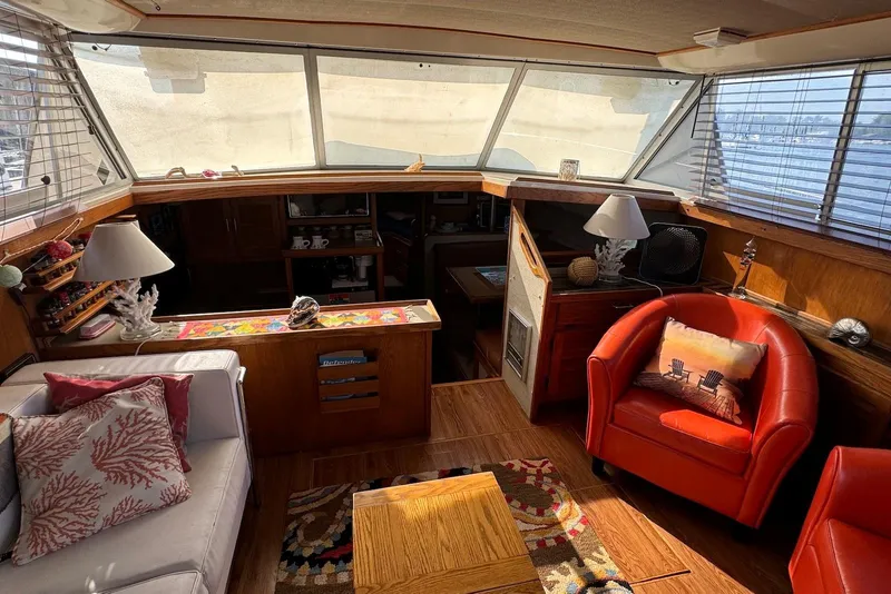 Slide: The Image of Interior of a 1985 Silverton 40 Aft Cabin yacht with cozy seating and nautical decor. - 17