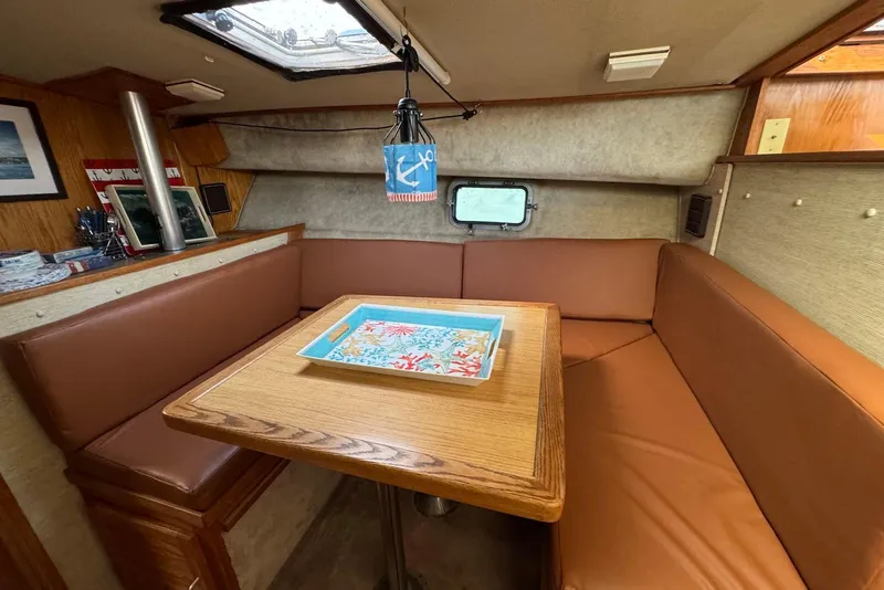 Slide: The Image of 1985 Silverton 40 Aft Cabin interior with cozy seating and nautical decor. - 21