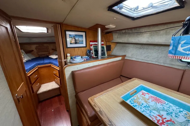 Slide: The Image of Interior of 1985 Silverton 40 Aft Cabin with cozy seating and nautical decor. - 22