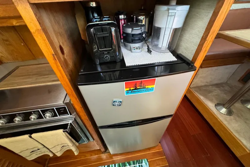 Slide: The Image of 1985 Silverton 40 Aft Cabin kitchen with appliances and mini fridge. - 28
