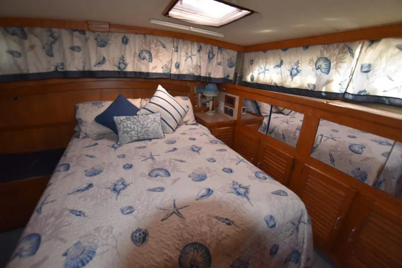 Slide: The Image of Cozy bedroom in 1985 Silverton 40 Aft Cabin with nautical-themed decor. - 29