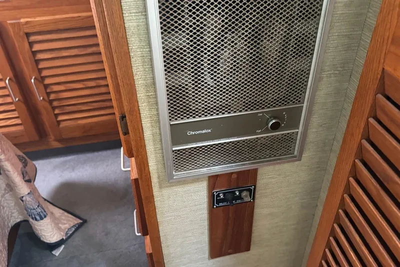 Slide: The Image of 1985 Silverton 40 Aft Cabin interior with Chromalox heater and wooden cabinetry. - 40