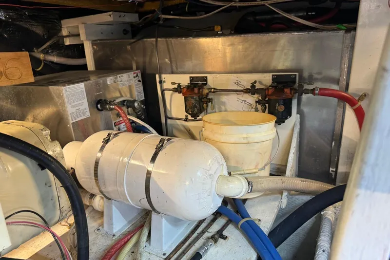 Slide: The Image of Engine room of a 1985 Silverton 40 Aft Cabin boat, featuring mechanical components. - 48