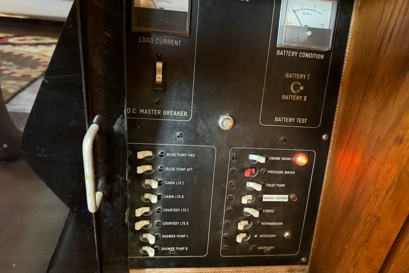Slide: The Image of Electrical panel of a 1985 Silverton 40 Aft Cabin boat, showing switches and gauges. - 49