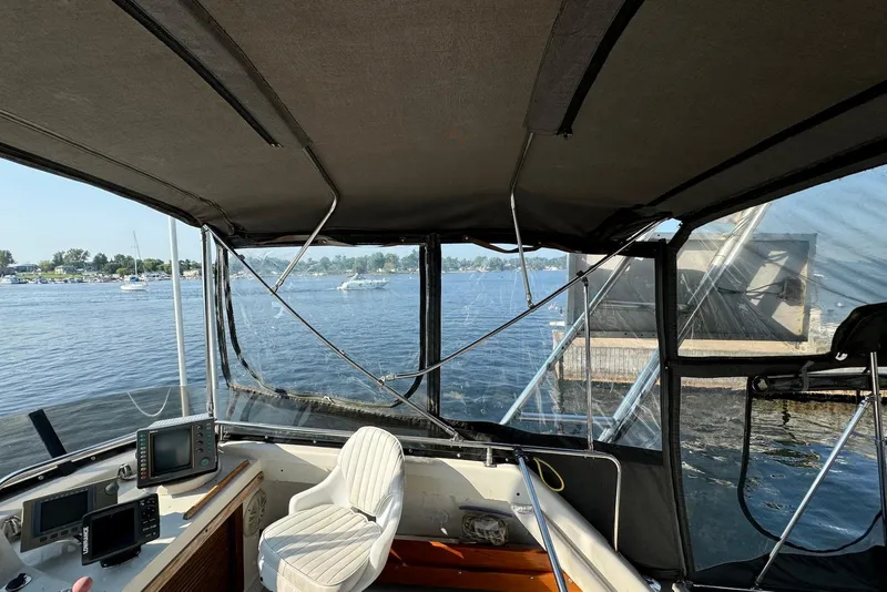 Slide: The Image of Interior view of 1985 Silverton 40 Aft Cabin boat with lake scenery. - 5