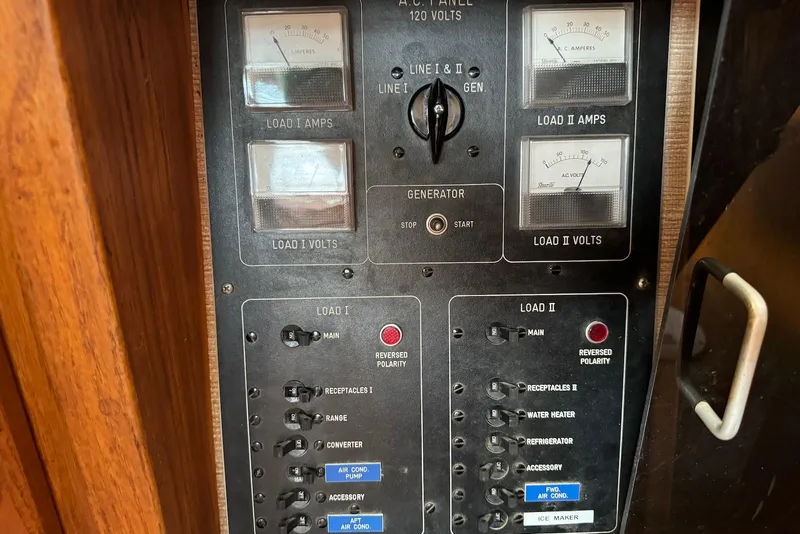 Slide: The Image of Electrical control panel of a 1985 Silverton 40 Aft Cabin boat, featuring various switches and meters. - 50