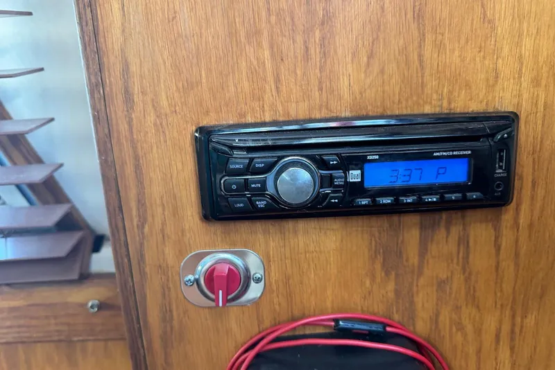 Slide: The Image of 1985 Silverton 40 Aft Cabin interior with stereo system and control panel. - 52