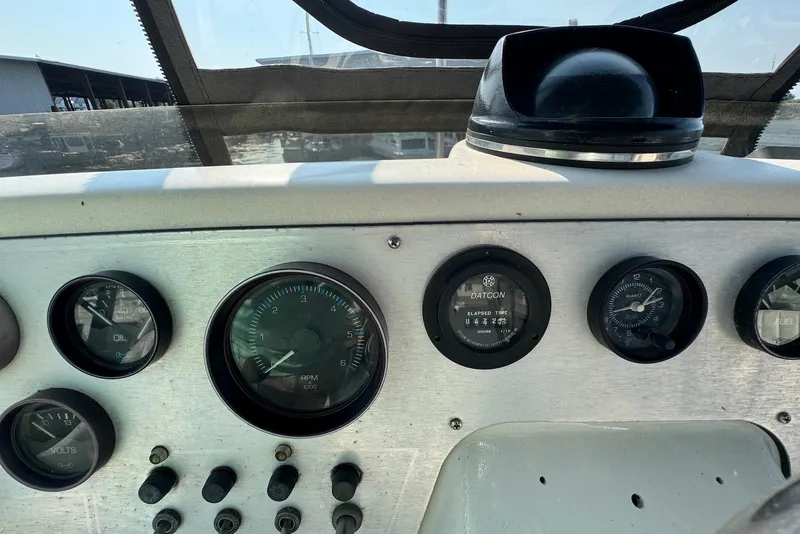 Slide: The Image of Dashboard of a 1985 Silverton 40 Aft Cabin boat with gauges and controls. - 7