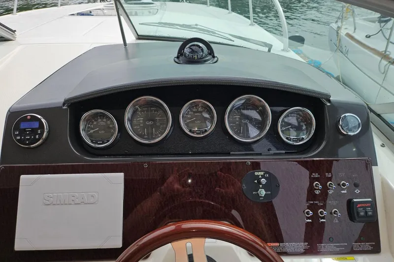 Slide: The Image of Dashboard of a 2012 Sea Ray Sundancer 310 boat with gauges and controls. - 10