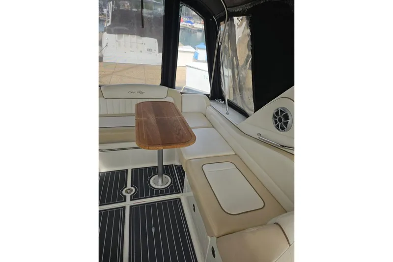 Slide: The Image of Interior of 2012 Sea Ray Sundancer 310 with seating and wooden table. - 14