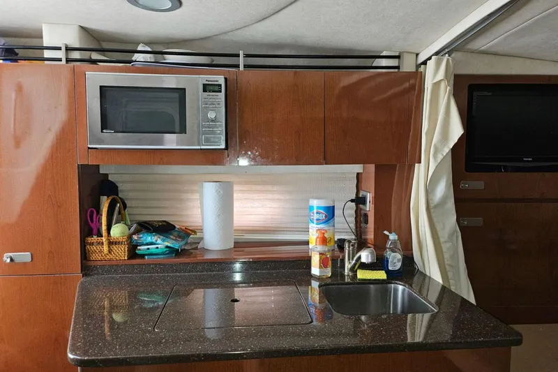 Slide: The Image of Interior of 2012 Sea Ray Sundancer 310 with kitchenette, microwave, and sink. - 16
