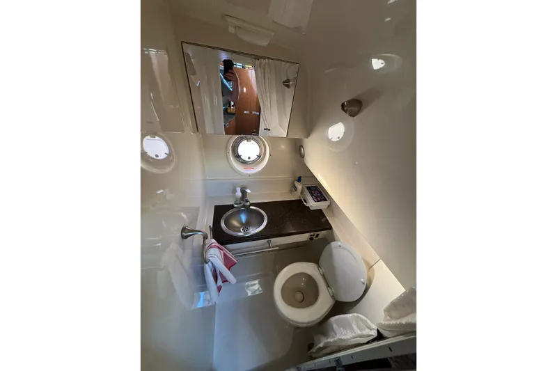 Slide: The Image of 2012 Sea Ray Sundancer 310 bathroom with sink, toilet, and mirror. - 18