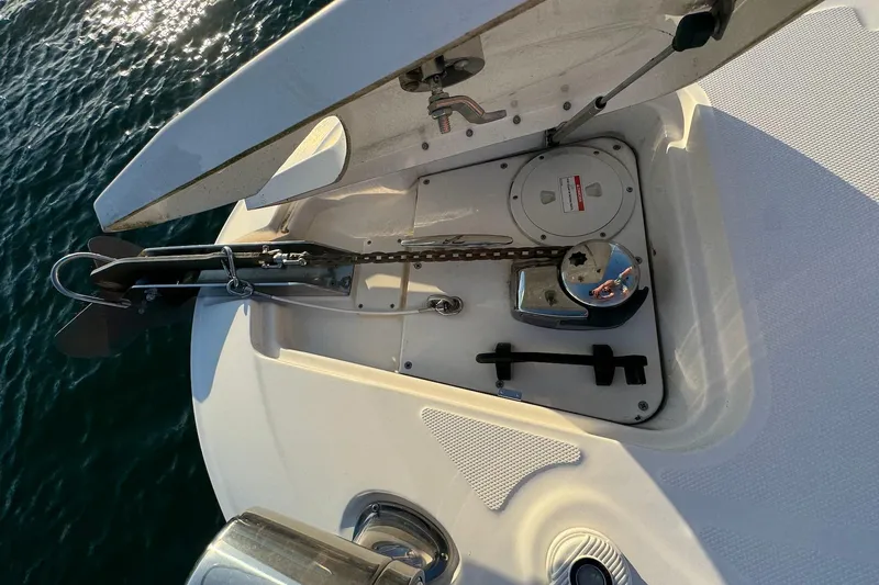 Slide: The Image of Anchor compartment of a 2012 Sea Ray Sundancer 310 boat, open on calm water. - 20