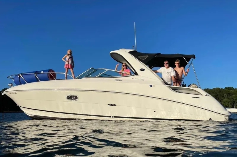 Slide: The Image of 2012 Sea Ray Sundancer 310 with people enjoying a sunny day on the water. - 6