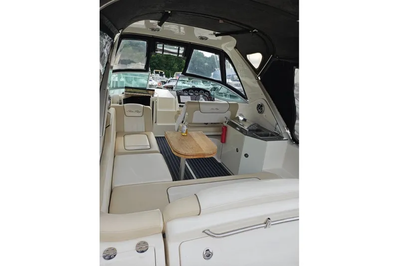 Slide: The Image of 2012 Sea Ray Sundancer 310 interior with seating, table, and helm. - 8