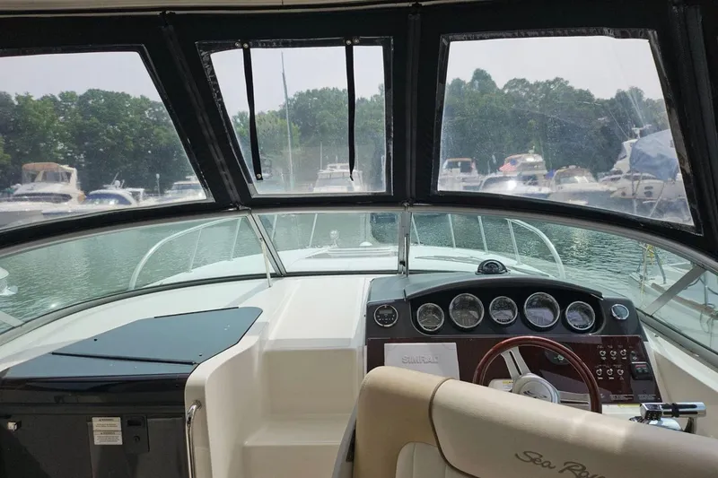 Slide: The Image of Interior view of 2012 Sea Ray Sundancer 310 boat cockpit with dashboard and steering wheel. - 9