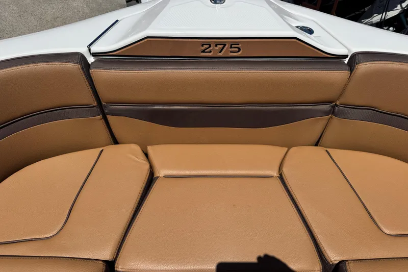 Slide: The Image of 2025 Yamaha Boats 275SE interior with tan and brown seating. - 12