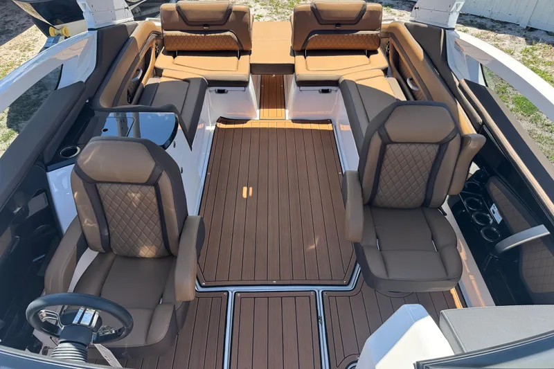 Slide: The Image of 2025 Yamaha Boats 275SE interior with luxurious brown seating and sleek design. - 15