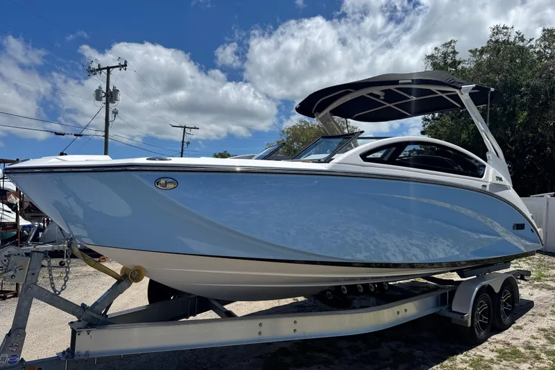 Slide: The Image of 2025 Yamaha Boats 275SE on trailer under blue sky with clouds. - 2