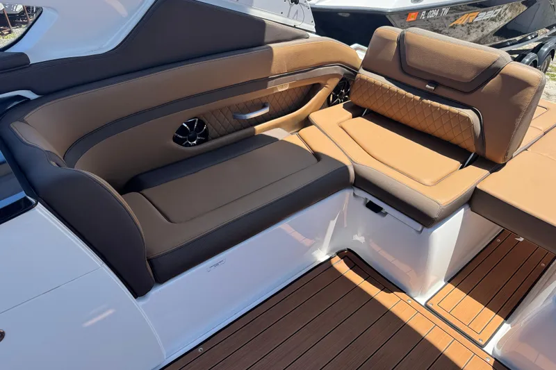 Slide: The Image of 2025 Yamaha Boats 275SE interior with luxurious brown seating and stylish design. - 20