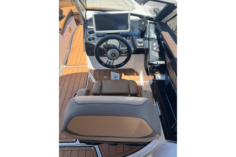 Slide: The Image of 2025 Yamaha Boats 275SE cockpit with modern steering and dashboard controls. - 22