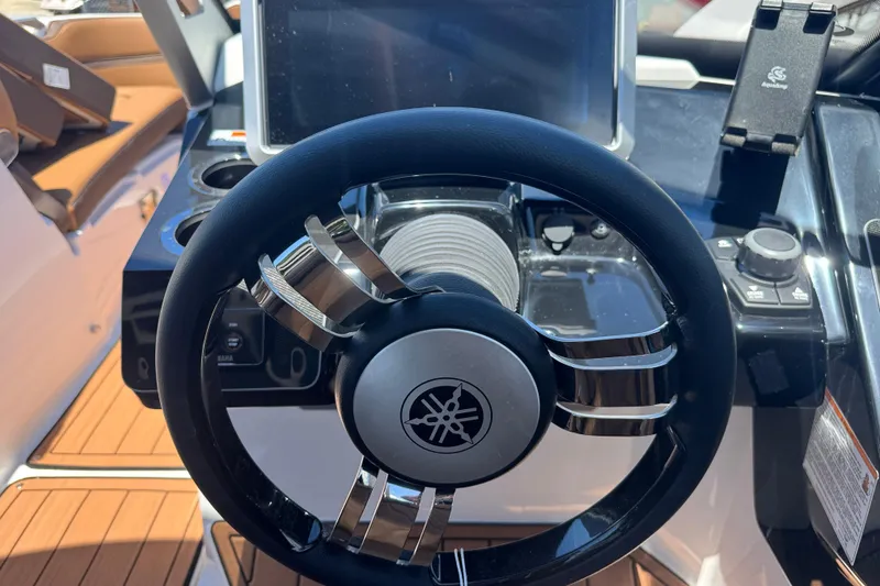 Slide: The Image of Steering wheel of 2025 Yamaha Boats 275SE, featuring modern dashboard controls. - 25