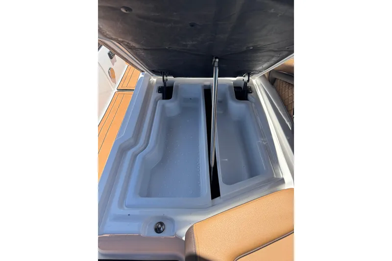 Slide: The Image of 2025 Yamaha Boats 275SE storage compartment with open lid, showcasing spacious interior design. - 28