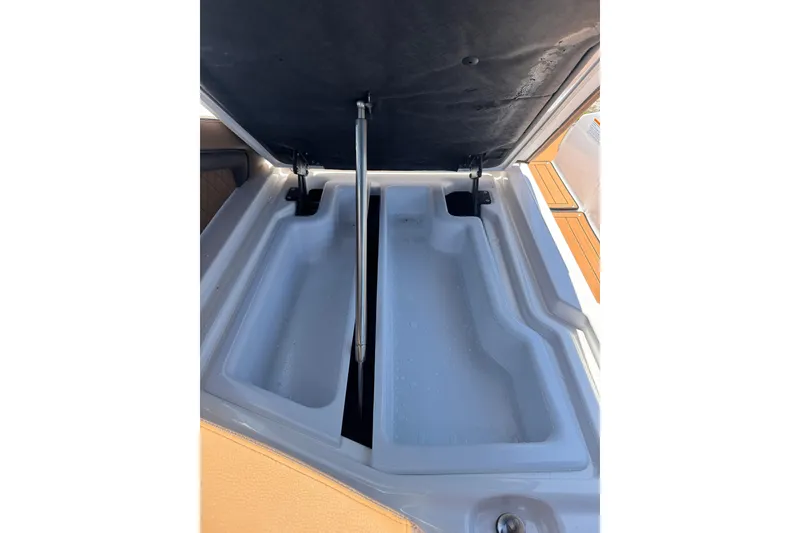 Slide: The Image of Open storage compartment on 2025 Yamaha Boats 275SE, showcasing spacious interior design. - 30